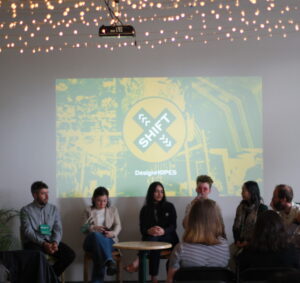 a photograph of Rosie speaking on a panel at Design SHIFT symposium